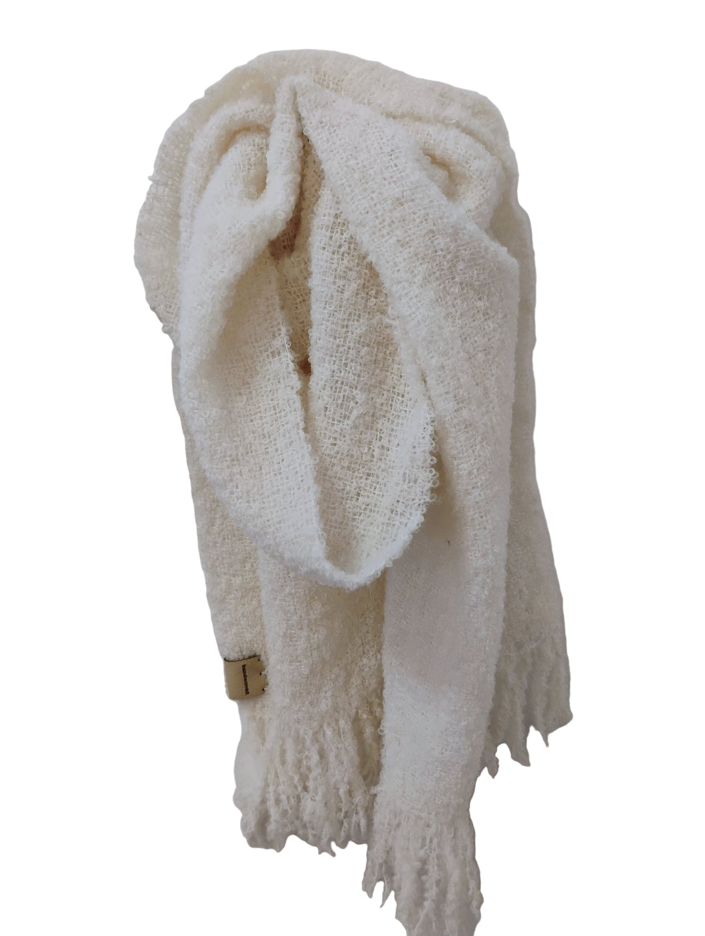 White, alpaca boucle scarf haning on wall